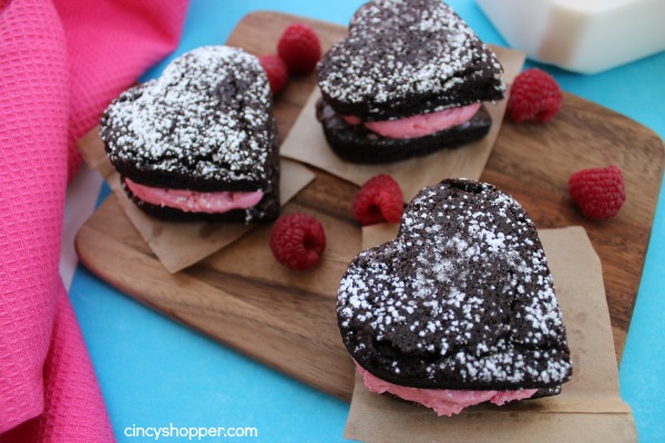 Heart Brownies with Raspberry Buttercream filling- A fudgy brownie in a heart shape filled with a yummy raspberry buttercream filling. Perfect for Valentines Day!