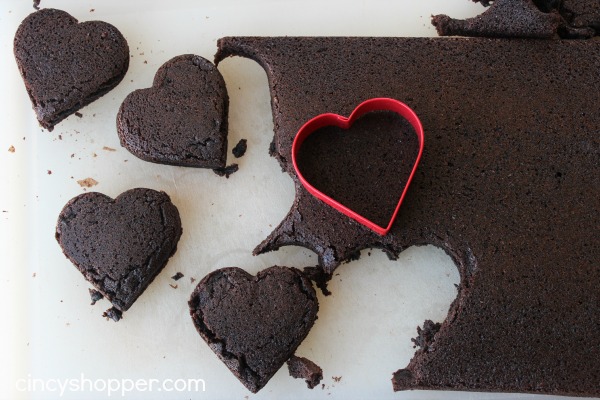 Heart Brownies with Raspberry Buttercream filling- A fudgy brownie in a heart shape filled with a yummy raspberry buttercream filling. Perfect for Valentines Day!