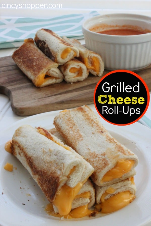 photo of 4 stacked grilled cheese rollups with more rollups in the background