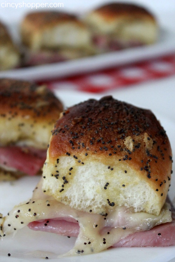 Ham and Swiss Sliders Recipe- Loaded with ham, swiss cheese and a mustard sauce all baked up to perfection. These sandwiches are delicious and over the top messy (in a good way). Perfect for game day or any party you are looking to serve up a tasty slider to
