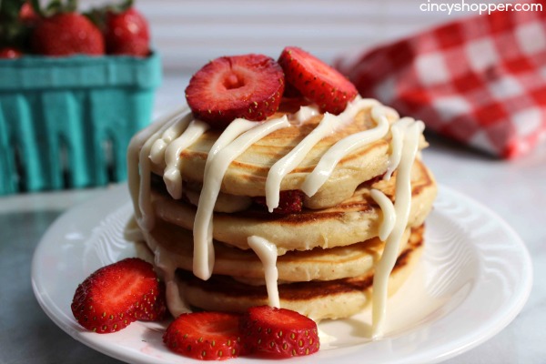 Strawberry Pancakes with Cream Cheese Glaze- pancakes are made with fresh strawberries and then topped with a sweet cream cheese glaze. Perfect for a wonderful weekend or even Valentine's breakfast!