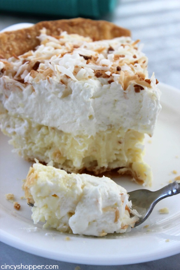 Slice of Coconut Cream Pie on a plate with a fork.