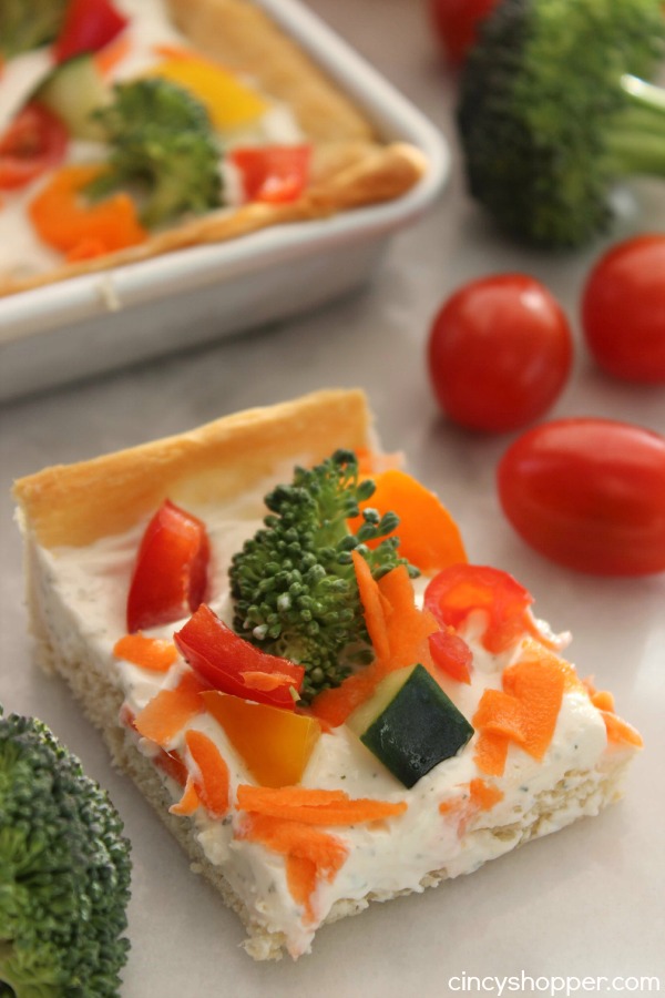 Veggie Pizza Bites- Crescent crust topped with ranch dip mixture then loaded with veggies. Perfect cold bite sized appetizer.