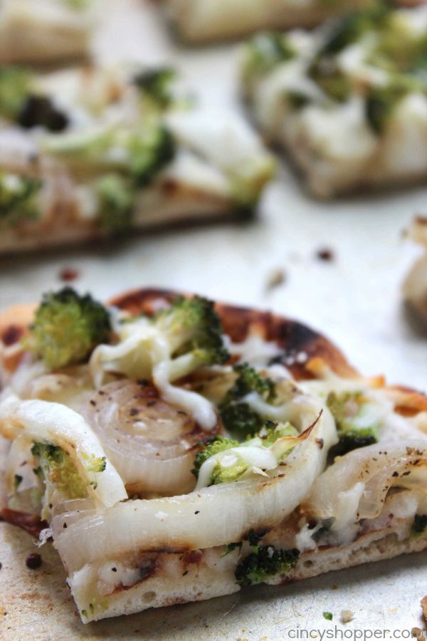 Broccoli Flatbread Pizza -loaded with broccoli, onions, cheese and lots of garlic. A super easy and quick weeknight meal that is sure to please.