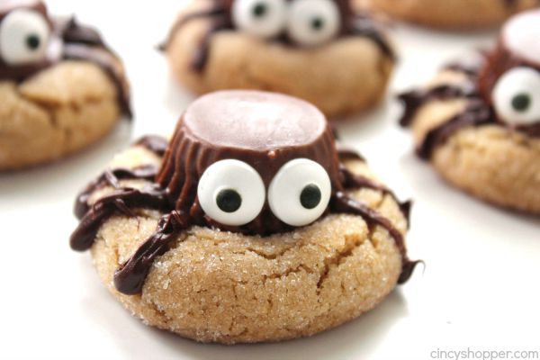 Halloween Spider Cookies - perfect party treat. We start with a simple peanut butter blossom cookie, top it with a Reese's Miniature, add on some eyes and some legs.