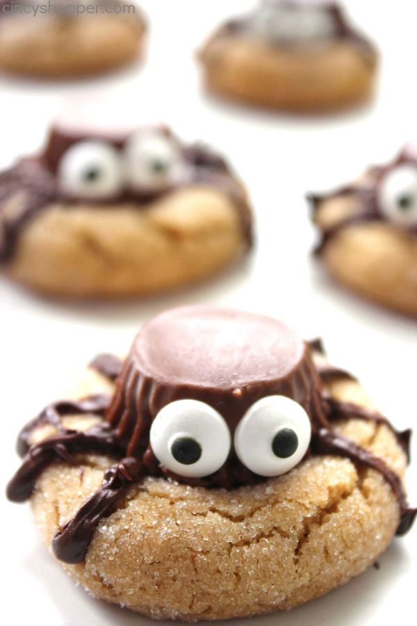 Halloween Spider Cookies - perfect party treat. We start with a simple peanut butter blossom cookie, top it with a Reese's Miniature, add on some eyes and some legs.