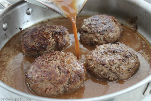 pouring gravy on hamburger steaks