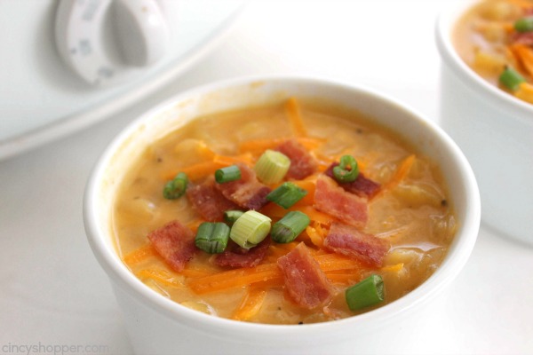 Slow Cooker Potato Soup - loaded with cheese and topped with bacon makes for a perfect winter meal. This cheesy soup is super simple and cooks all day right in your Crock-Pot.