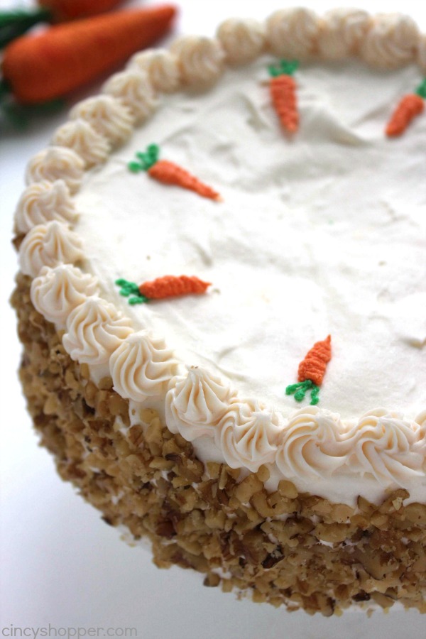 Carrot Cake Cheesecake - moist carrot cake with a hint of pineapple, coconut, raisins, and walnuts wrapped in a delicious cheesecake and then topped off with a perfect cream cheese frosting. Perfect Easter dessert.