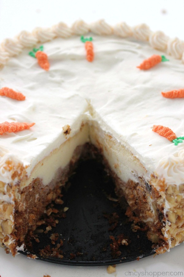 Carrot Cake Cheesecake - moist carrot cake with a hint of pineapple, coconut, raisins, and walnuts wrapped in a delicious cheesecake and then topped off with a perfect cream cheese frosting. Perfect Easter dessert.
