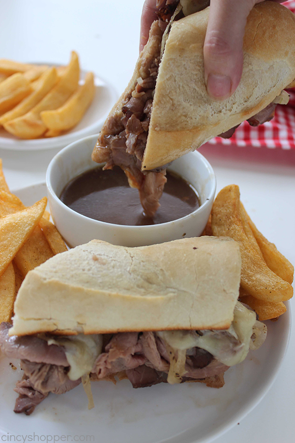 Easy French Dip Sandwiches - perfect quick family dinner. Store bought deli roast beef, cheese, onions, and homemade au jus for dipping. PERFECT!