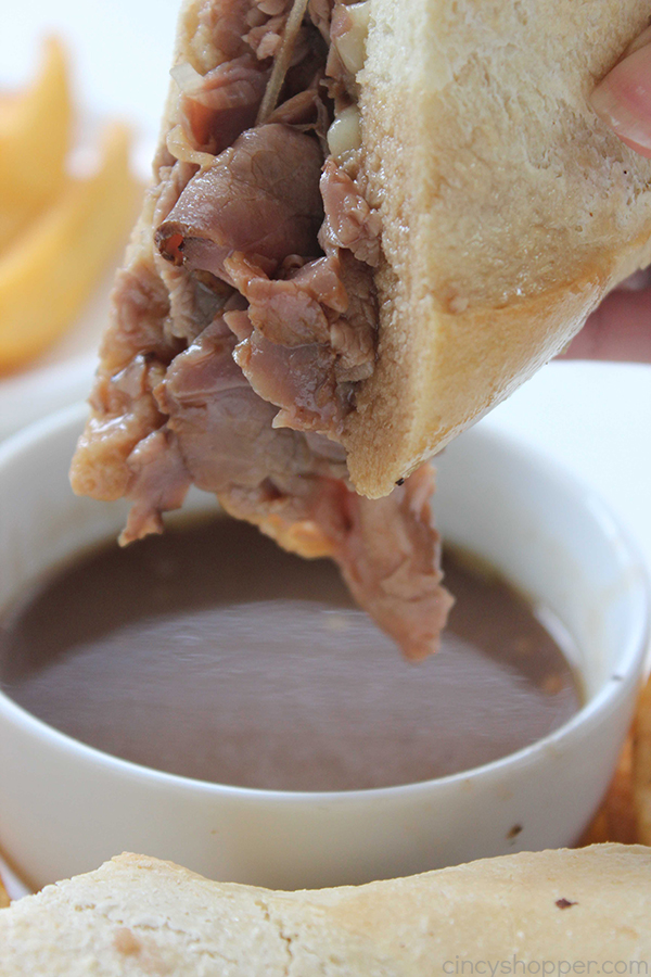 Easy French Dip Sandwiches - perfect quick family dinner. Store bought deli roast beef, cheese, onions, and homemade au jus for dipping. PERFECT!