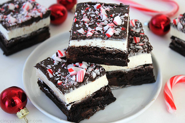 Peppermint Brownies - filled with a great peppermint buttercream frosting, a layer of chocolate frosting, and then topped with peppermint crunch sprinkles. Perfect for a Christmas dessert. Since they start with a boxed mix, they can be made quickly.