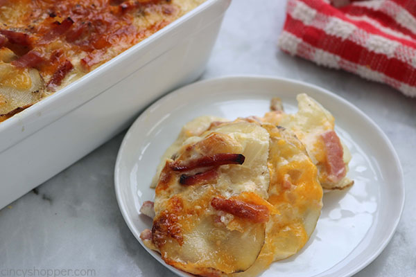 Scalloped Potatoes and Ham - a perfect casserole dish to serve up as a meal or side dish. You will find them loaded with lots of cream, cheese, and flavor. Great use of leftover holiday ham.