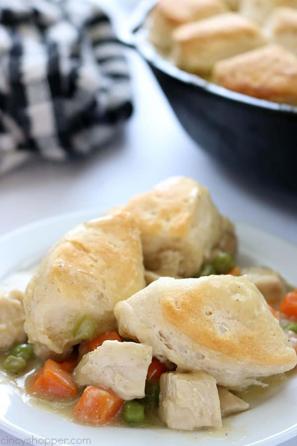 If you need a simple dinner idea, this Easy Skillet Chicken & Biscuits will be great for you to make. You will find it loaded with chicken, veggies and then topped with biscuits. #ChickenDinner