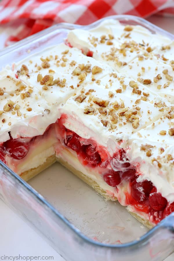 Easy Cherry Cheesecake Lush- a creamy cheesecake layer, then cheesecake pudding, cherry pie filling, and of course, a whipped topping. It's luscious and perfect for summer bbq's and potlucks. #cherrylush #summerdessert