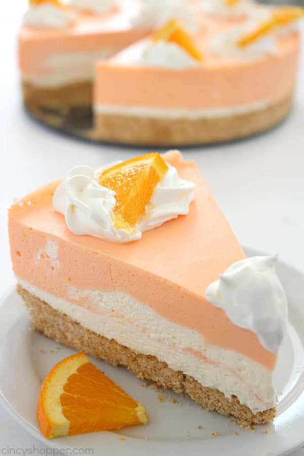 If you are a fan of Creamsicles, you are going to want to make this No Bake Orange Creamsicle Cheesecake this summer. You will find a delicious Nilla Cookie crust with layers of orange creamy cheesecake filling. Perfect for summer picnics and BBQ's. #Cheesecake #Creamsicle #Orangedessert