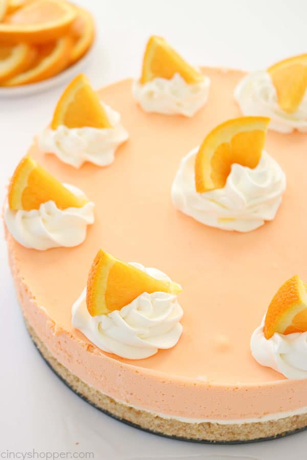 If you are a fan of Creamsicles, you are going to want to make this No Bake Orange Creamsicle Cheesecake this summer. You will find a delicious Nilla Cookie crust with layers of orange creamy cheesecake filling. Perfect for summer picnics and BBQ's. #Cheesecake #Creamsicle #Orangedessert