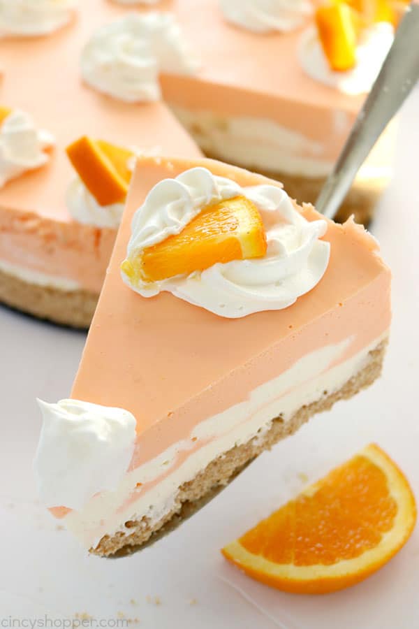 If you are a fan of Creamsicles, you are going to want to make this No Bake Orange Creamsicle Cheesecake this summer. You will find a delicious Nilla Cookie crust with layers of orange creamy cheesecake filling. Perfect for summer picnics and BBQ's. #Cheesecake #Creamsicle #Orangedessert