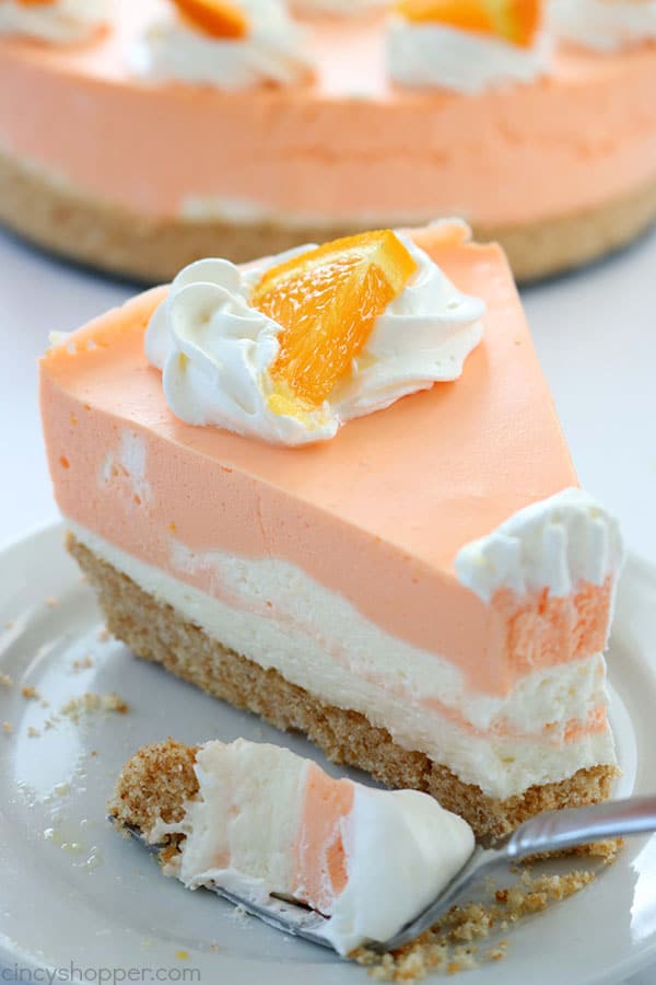 If you are a fan of Creamsicles, you are going to want to make this No Bake Orange Creamsicle Cheesecake this summer. You will find a delicious Nilla Cookie crust with layers of orange creamy cheesecake filling. Perfect for summer picnics and BBQ's. #Cheesecake #Creamsicle #Orangedessert