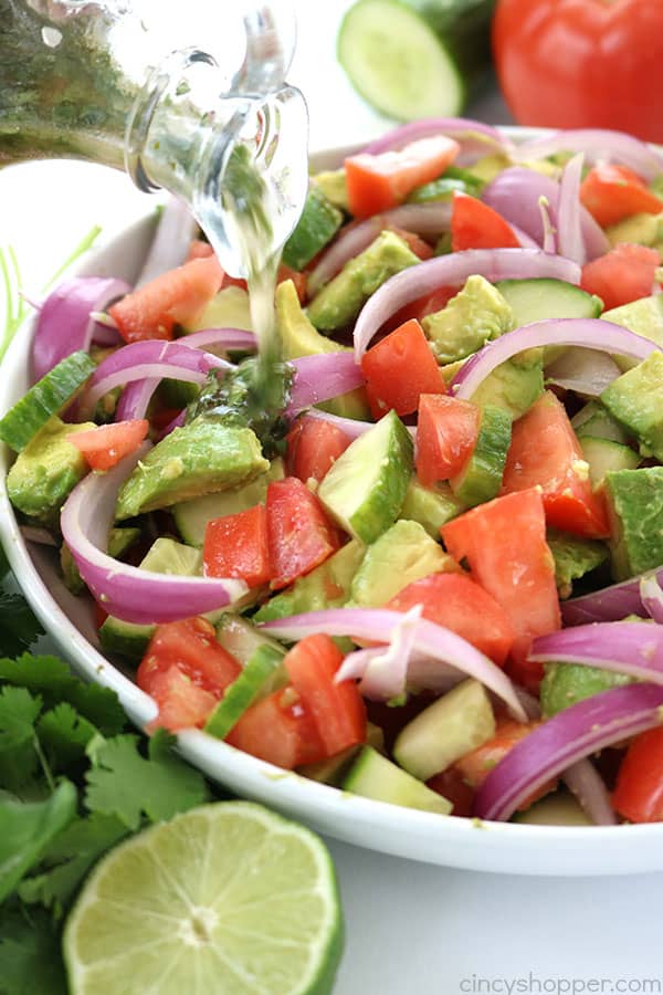 Tomato Avocado Salad with Cilantro Lime Balsamic Dressing - light and full of amazing flavor. Perfect for a summer side dish at your next BBQ or picnic. #SummerSalad #avocado