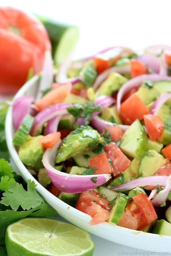 Tomato Avocado Salad with Cilantro Lime Balsamic Dressing - light and full of amazing flavor. Perfect for a summer side dish at your next BBQ or picnic. #SummerSalad #avocado