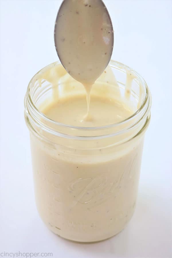 Easy Homemade Alfredo Sauce in a jar with a spoon