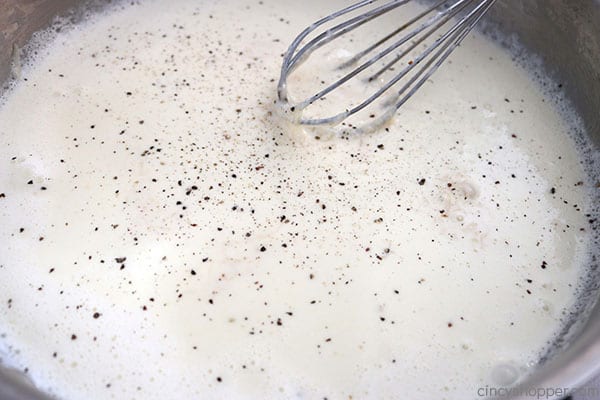 Alfredo sauce in a pan with pepper