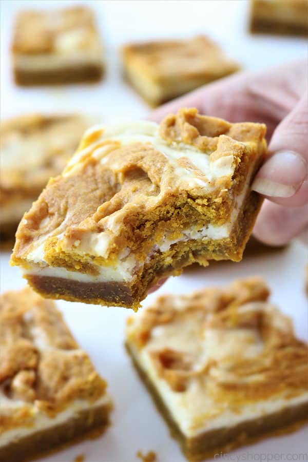 Swirled Pumpkin Cheesecake Bars - better than a pumpkin pie! Tasty pumpkin bar with a delicious swirled layer of cream cheese. Perfect fall and Thanksgiving dessert.