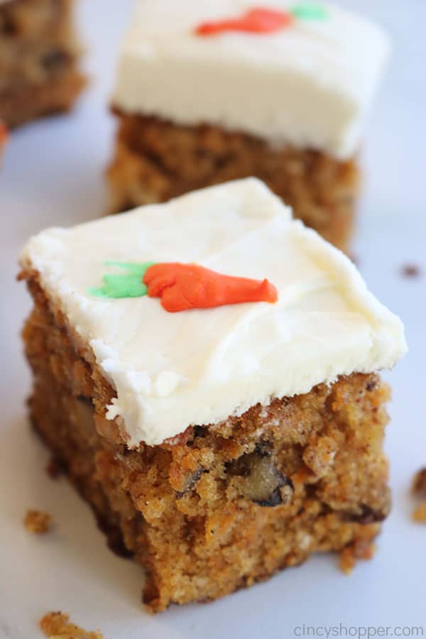 Pieces of carrot cake with cream cheese frosting.