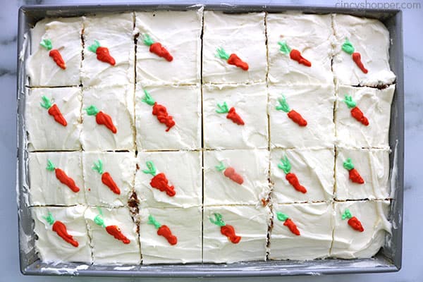 Cut carrot cake with sweet cream cheese frosting