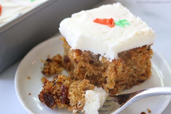 Fork on plate with carrot cake.