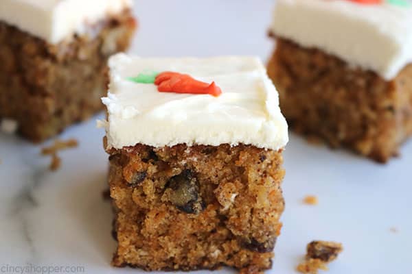 Three pieces of carrot cake with cream cheese frosting