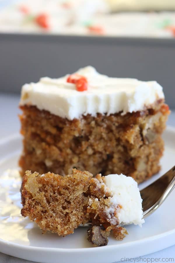 Slice of carrot cake with pineapple on plate.