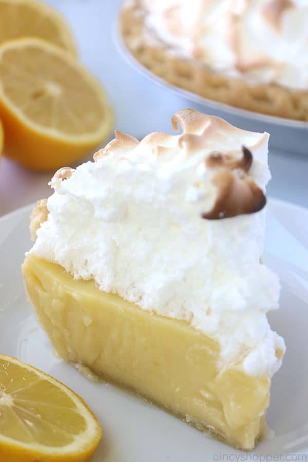 Slice of traditional lemon meringue pie on a plate.