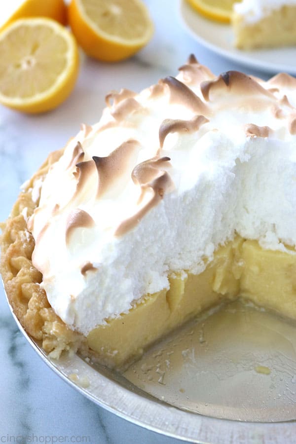 A cut lemon pie with meringue.