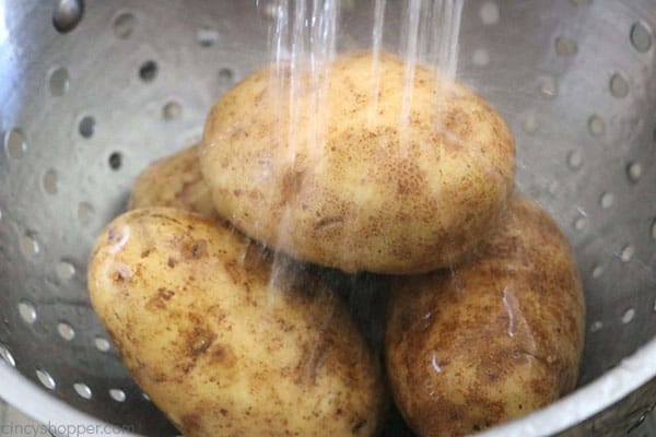 Washing potatoes in a colander. 