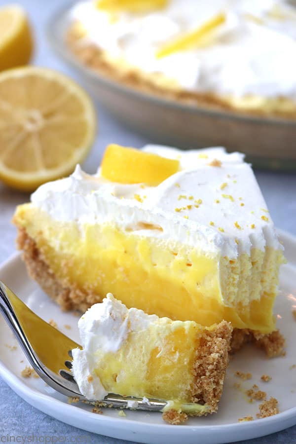 Slice of lemon pie on plate with fork.
