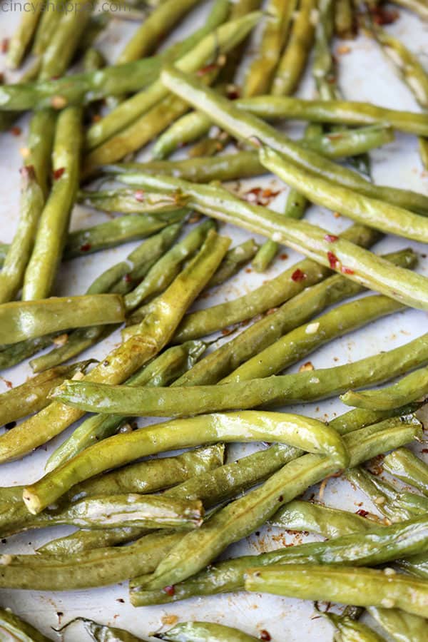 Roasted green beans on a sheet pan.