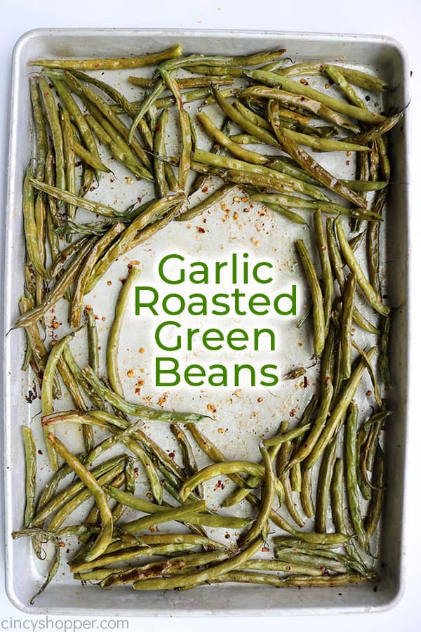 Roasted green beans on a sheet pan with text.
