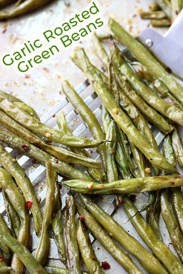 Garlic roasted green beans on a pan with text.