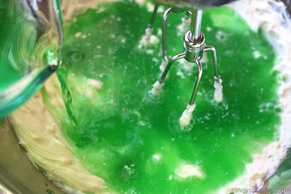 Adding lime Jello to cream cheese mixture.