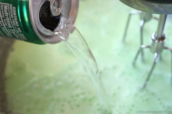 Adding 7UP to lime Jello salad.