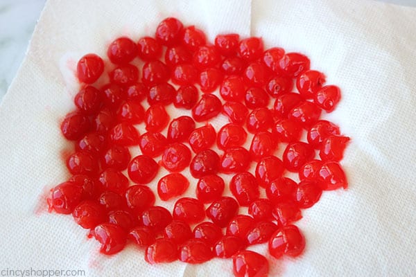 Sliced cherries on a paper towel.