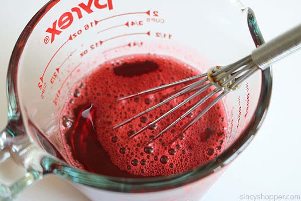 Making Jello for strawberry poke cake.