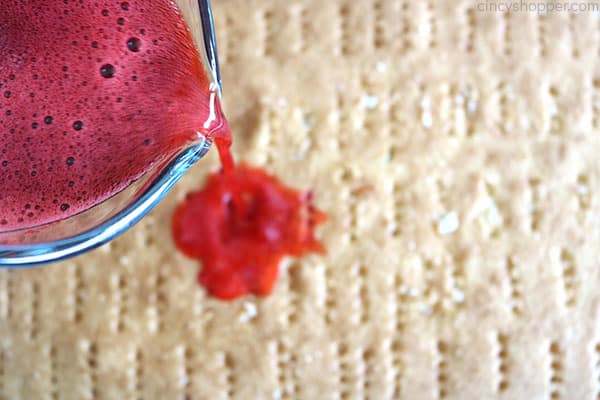 Pouring Jello on poke cake.