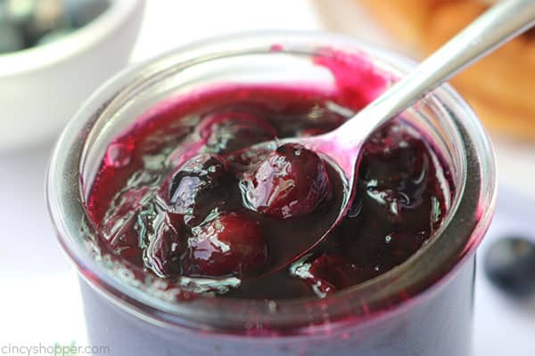 Blueberry sauce in a jar with a spoon