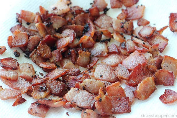 Fried bacon pieces on a paper towel.