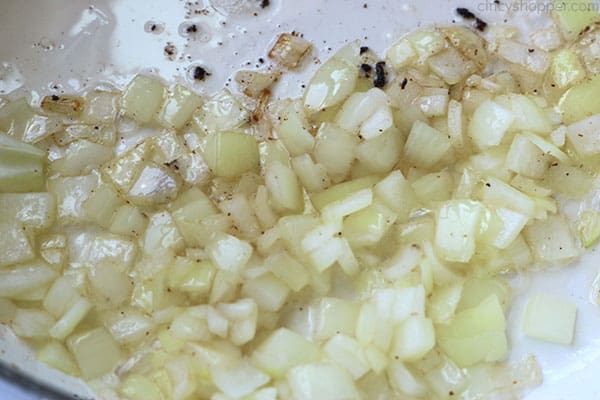 Diced onions cooking in a pan.