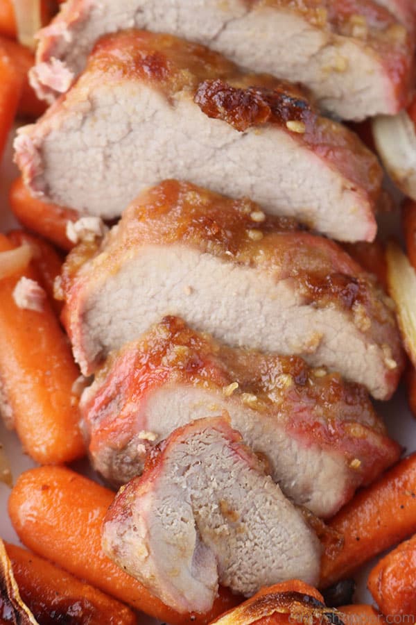 Sliced Garlic Brown Sugar Pork Tenderloin on a sheet pan.